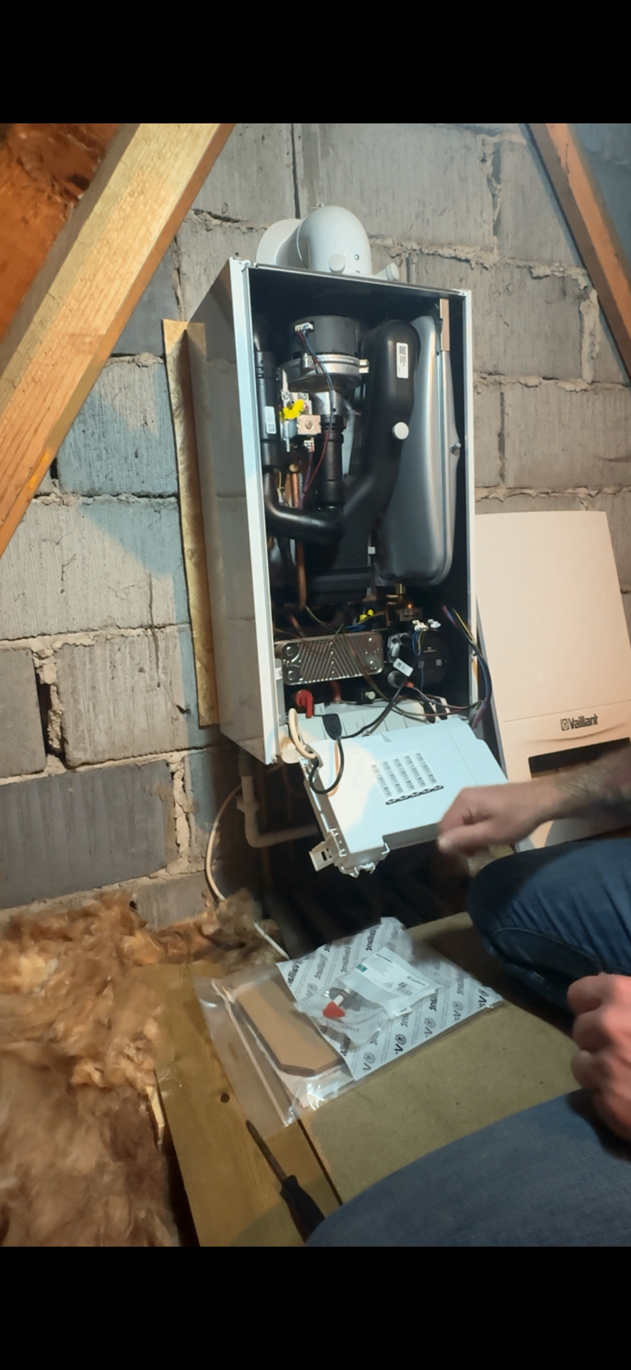 Vaillant boiler opened up showing internal heat exchanger and components during service